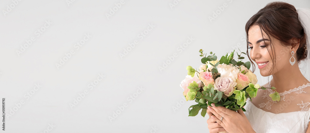 Beautiful young bride with bouquet of flowers on light background. Banner for design Beautiful young bride with bouquet of flowers on light background. Banner for design