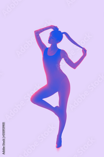 Silhouette of beautiful young woman on lilac background