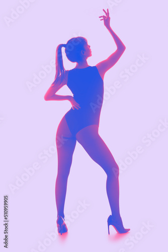 Silhouette of beautiful young woman on lilac background
