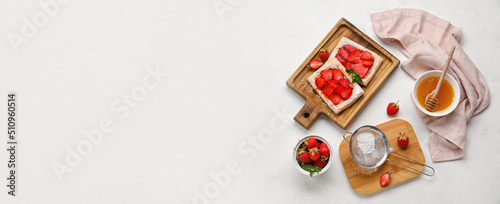 Composition with sweet strawberry puff pastries on light background with space for text photo