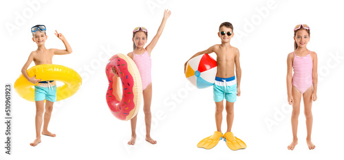 Set of cute little children in beachwear, with paddles, ball and inflatable rings isolated on white photo