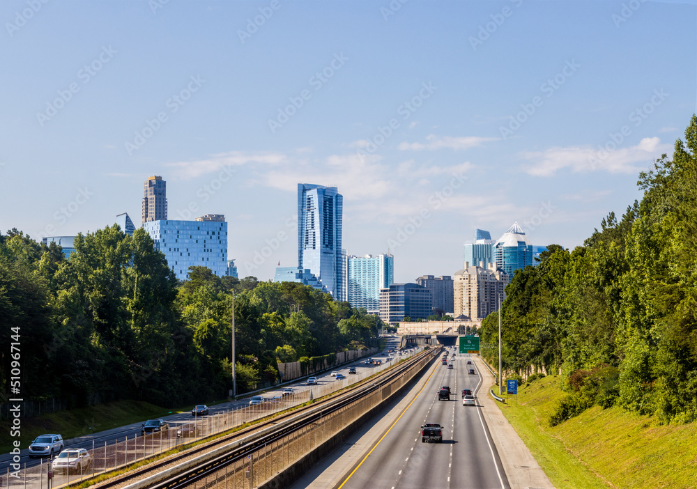 North Atlanta neighborhood of Buckhead displaying several buildings, city streets, hotels and high rises under a blue sky.