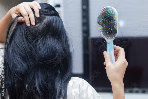 Closeup of comb brush with long loss hair with copy space-Healthcare concept.Selective focus. photo