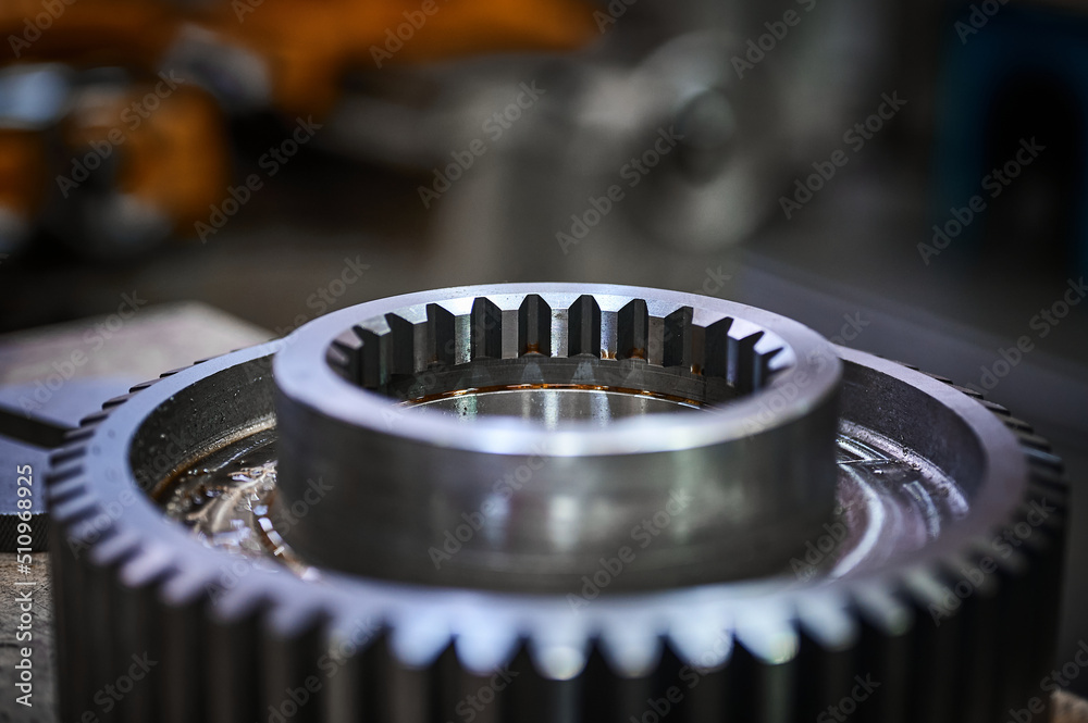 Pile of metal cogwheels for spiral gear drive in warehouse Pile of metal cogwheels for spiral gear drive in warehouse