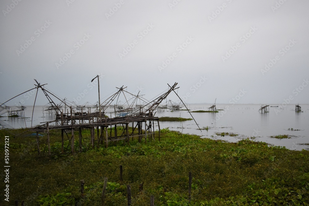 The giant fishing constructions, It is signature fishing trap and traditional fishing style of Pak Pra fishing village, Phatthalung, THAILAND. The giant fishing constructions, It is signature fishing trap and traditional fishing style of Pak Pra fishing village, Phatthalung, THAILAND.