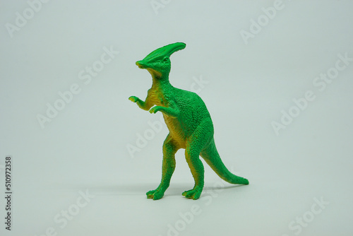 Side view of plastic Parasaurolophus dinosaur plastic toy for kids, isolated on a studio lighting background © LADALIDI