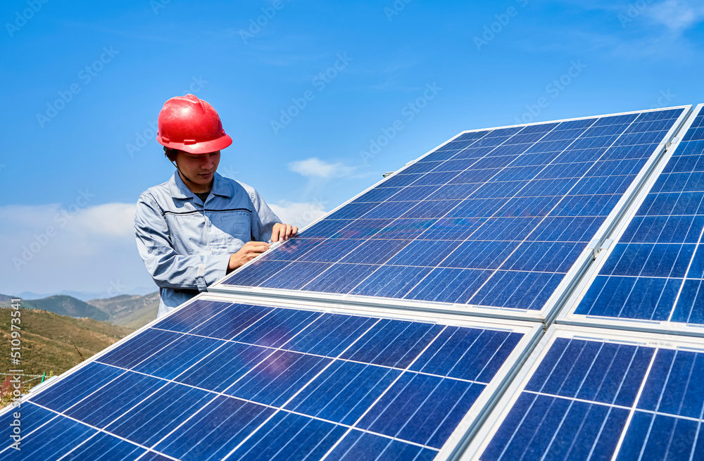 Asian workers are checking solar photovoltaic panels Asian workers are checking solar photovoltaic panels