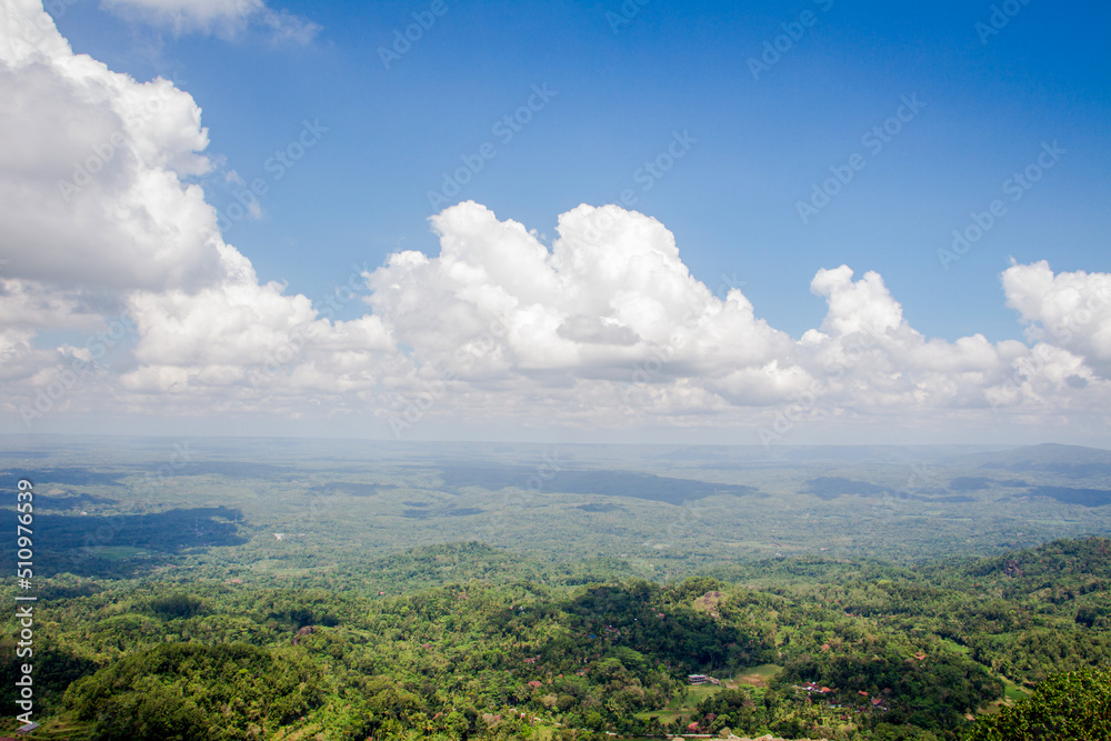 collection of clouds in blue sky in summer with wilderness view.