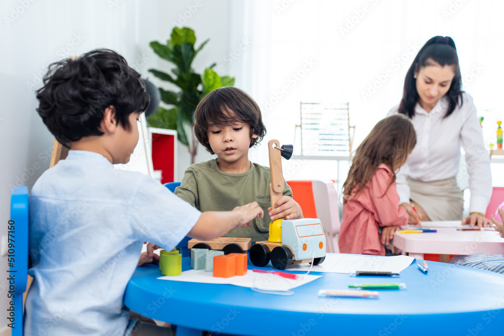 Caucasian beautiful woman teacher teaching a lesson to kid at school. Caucasian beautiful woman teacher teaching a lesson to kid at school.