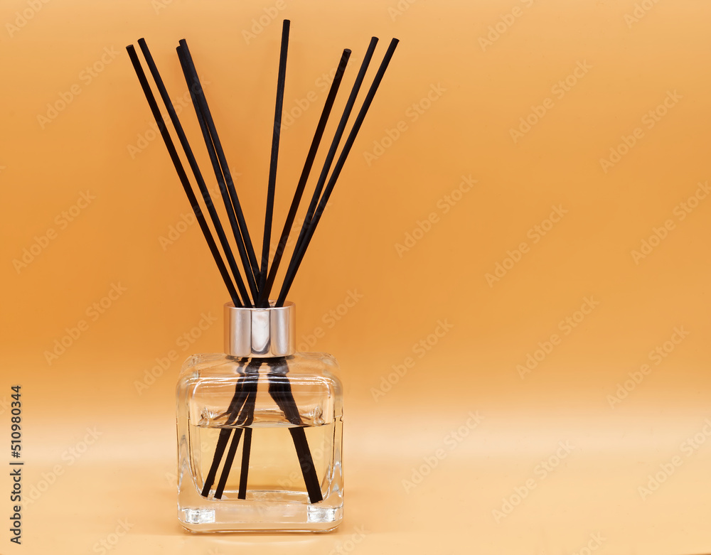 Air freshener sticks isolated on beige background. Aroma sticks and essential oil bottle for relaxation Air freshener sticks isolated on beige background. Aroma sticks and essential oil bottle for relaxation