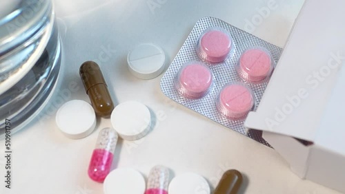 Blister and various tablets close-up on a white background
