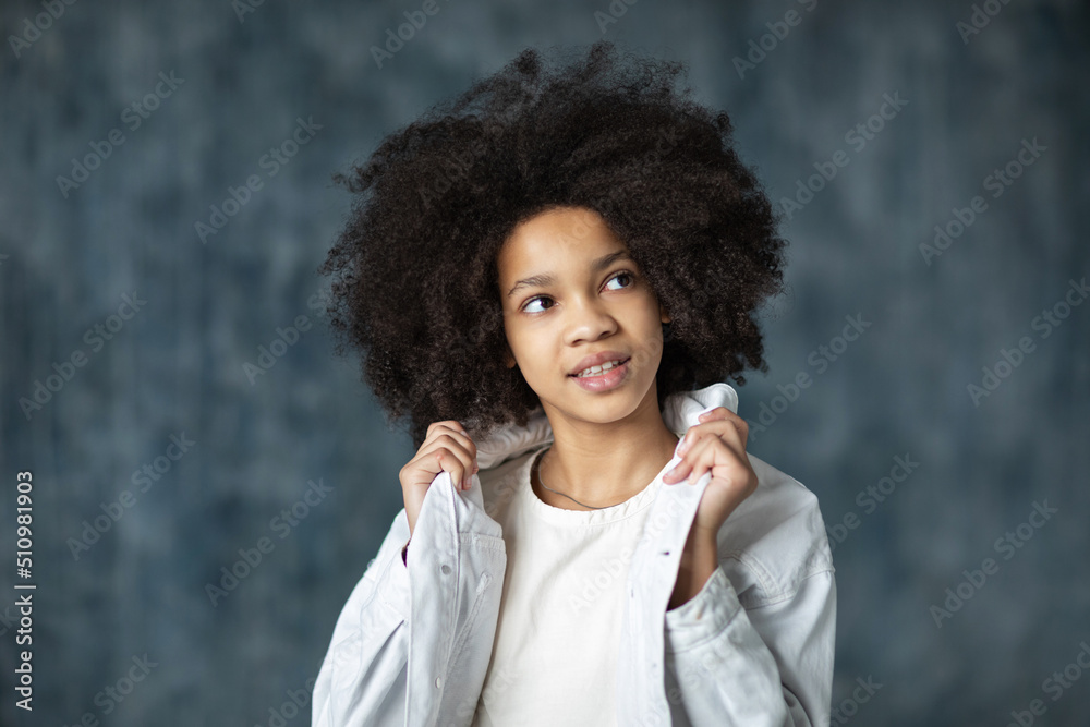 African happy beautiful young girl with curly hair smiling wearing casual clothes. African happy beautiful young girl with curly hair smiling wearing casual clothes.