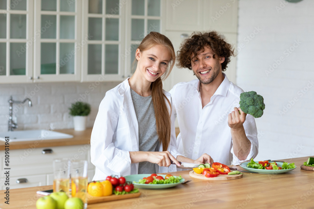 Young beautiful healthy couple preparing a vegetarian breakfast. Spending time together at home, healthy food. Young beautiful healthy couple preparing a vegetarian breakfast. Spending time together at home, healthy food.