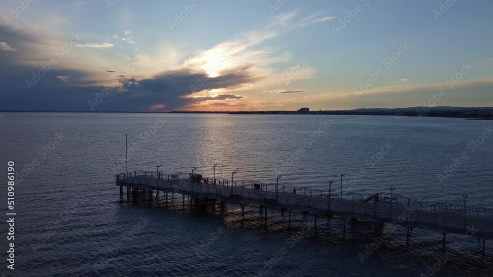 Side view of the pier on the Black Sea against the background of the sky and sunset Side view of the pier on the Black Sea against the background of the sky and sunset
