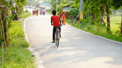 boy playing cycle on road
