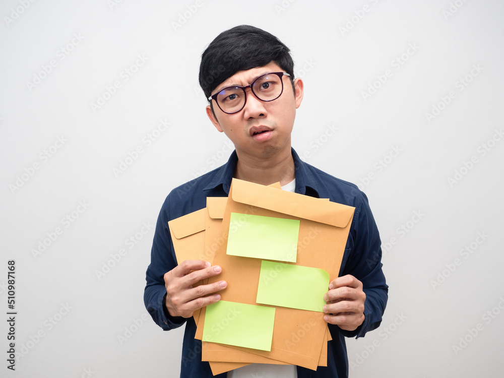 Young businessman holding envelope papers feel tried about work Young businessman holding envelope papers feel tried about work