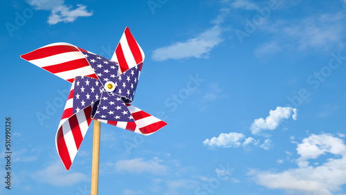 Pinwheel or windmill with USA flag as texture against bright blue sky. American's happiness concept. photo