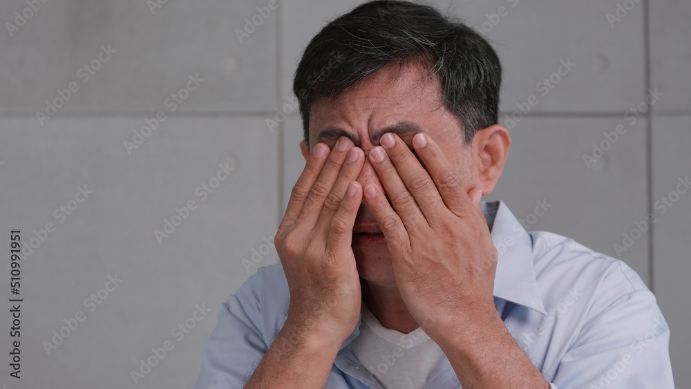 Asian old man was rubbing his eyes, tired of staring for a long time. Asian old man was rubbing his eyes, tired of staring for a long time.