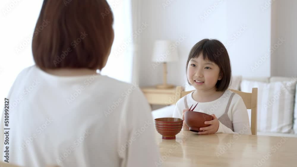 お母さんと一緒にご飯を食べる女の子