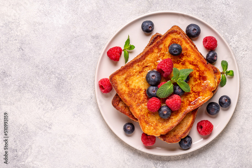 French toast with blueberries, raspberries, maple syrup photo