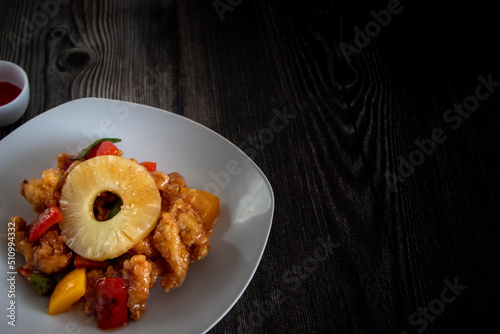 Sweet and sour chicken with pineapple and vegetables, Peruvian-Chinese cuisine photo
