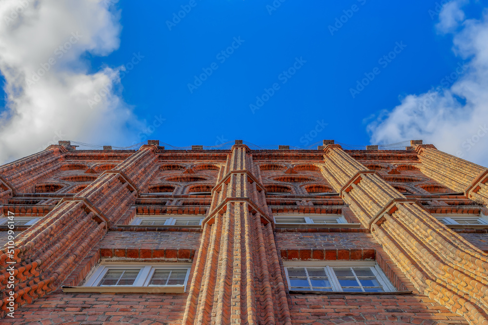 A medieval brick tenement house seen from below in Gdansk, Poland