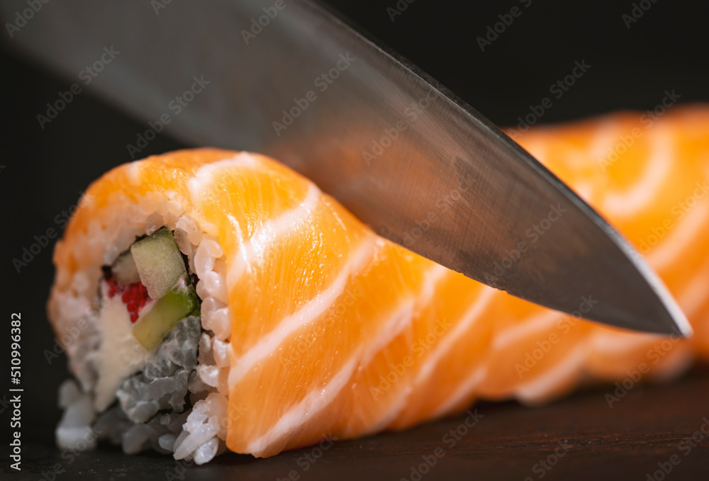Cook hands making sushi roll closeup photo Cook hands making sushi roll closeup photo