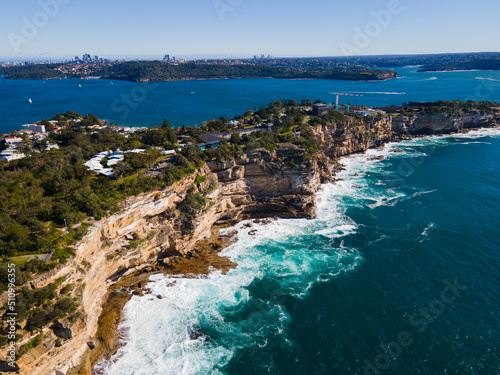 Aerial drone view of Watsons Bay in East Sydney, Australia looking toward South Head along the coastal clifftop on a sunny day photo