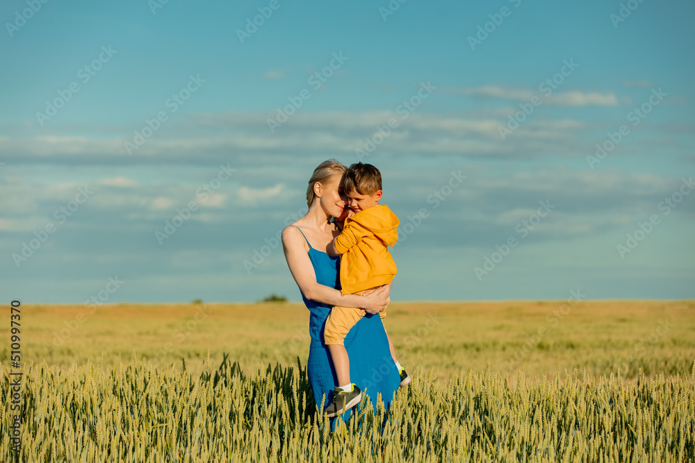 Mother with son in ukrainian national colors in wheat fie Mother with son in ukrainian national colors in wheat fie