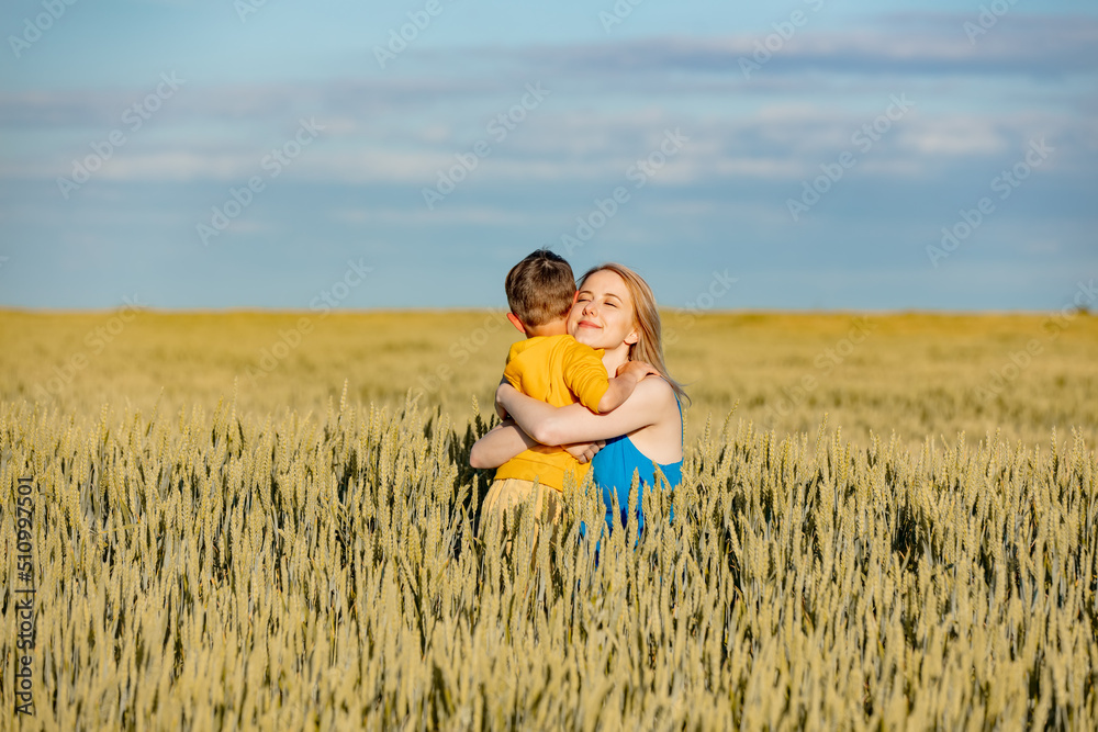 Mother with son in ukrainian national colors in wheat fie Mother with son in ukrainian national colors in wheat fie