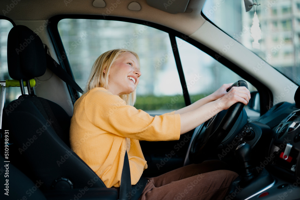 Beautiful woman driving a car. Happy woman going on the trip. Beautiful woman driving a car. Happy woman going on the trip.