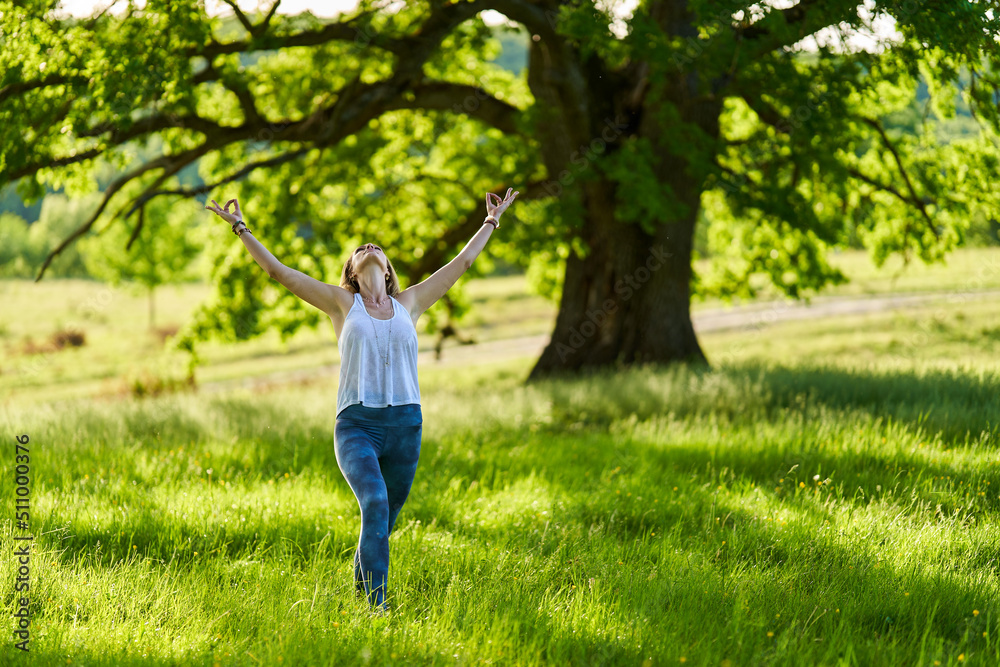 Young woman yoga practitioner in the forest