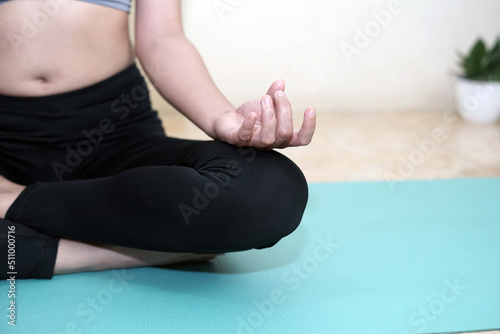A woman doing yoga at home