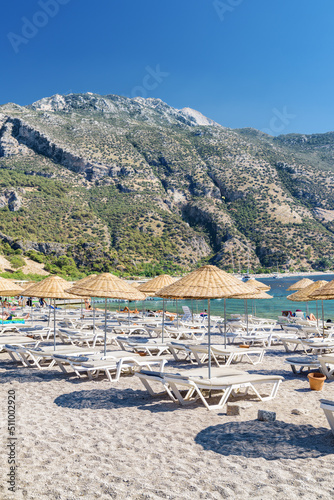 Beach umbrellas and sun loungers on Oludeniz Beach in Turkey