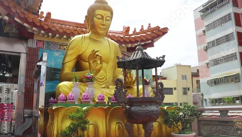Big Golden Śākyamuni Buddha statue in Taiwan Taichung temple, Chinese culture with Chinese traditional building eaves and Chinese incense burner photo