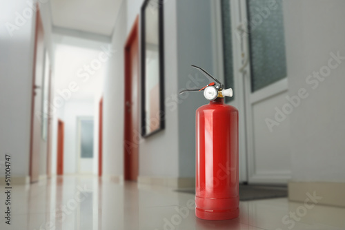 Wallpaper Mural Fire extinguisher on floor in office corridor. Space for text Torontodigital.ca