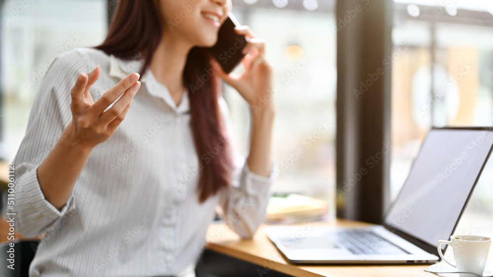 Businesswoman talking on the phone with her potential client or trying to close a business deal