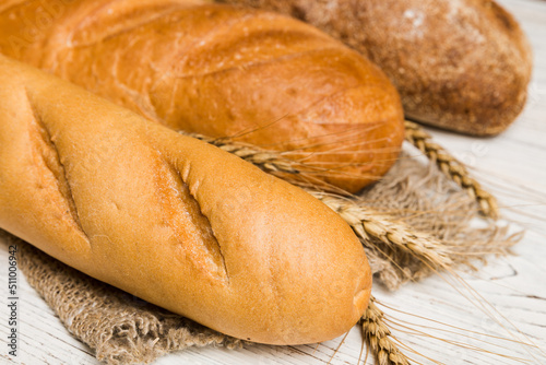 Homemade natural breads. Different kinds of fresh bread as background, perspective view with copy space