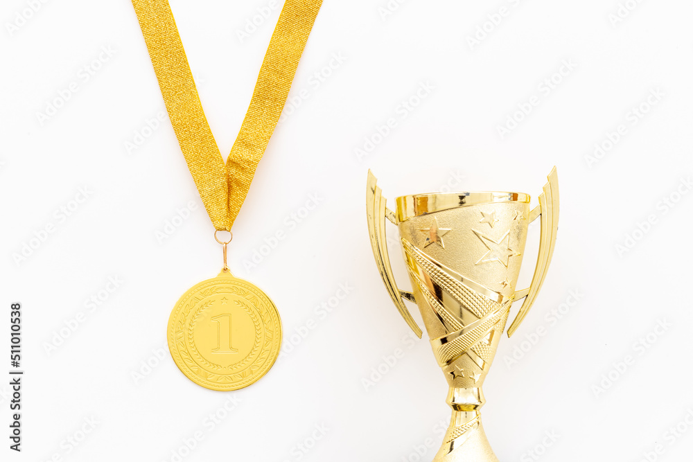 Winner concept with gold medal first place and award trophy cup