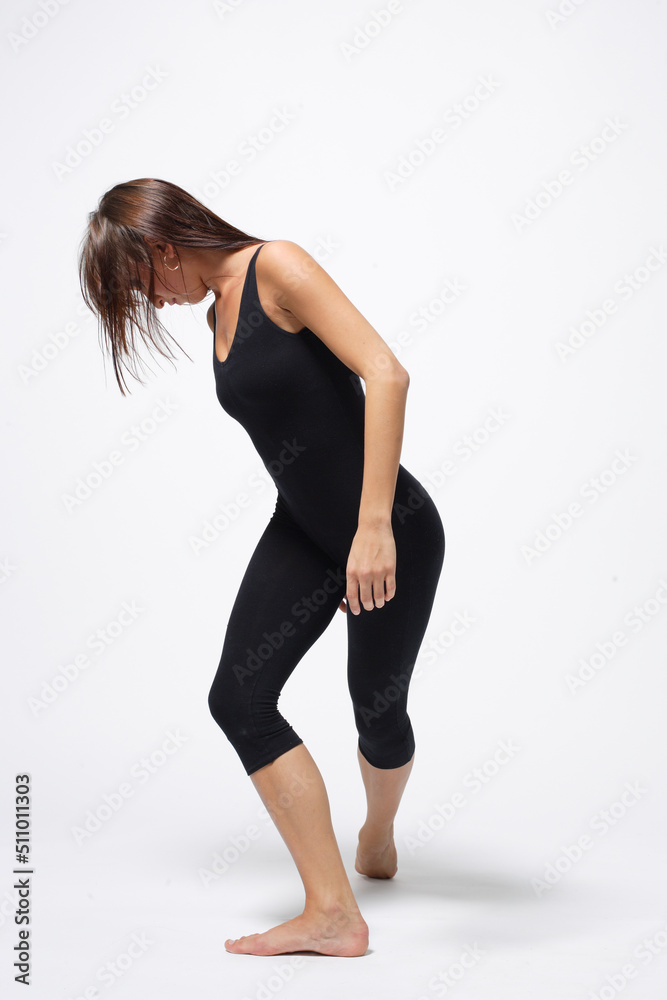 Young modern ballet woman dancer dancing on gray studio background Young modern ballet woman dancer dancing on gray studio background