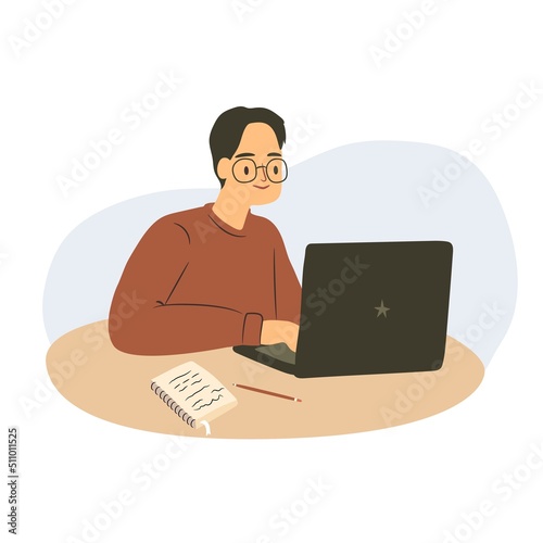 Student sitting a desk with a laptop. Working man