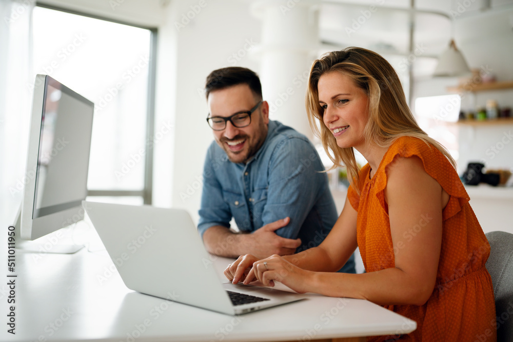 Portrait of success business people working together in home office. Couple teamwork startup concept Portrait of success business people working together in home office. Couple teamwork startup concept
