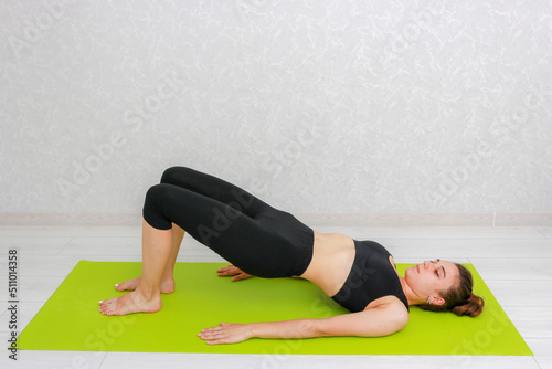Fototapeta Naklejka Na Ścianę i Meble -  Woman beginner doing yoga. Woman doing sports at home. Yoga and meditation positions.
