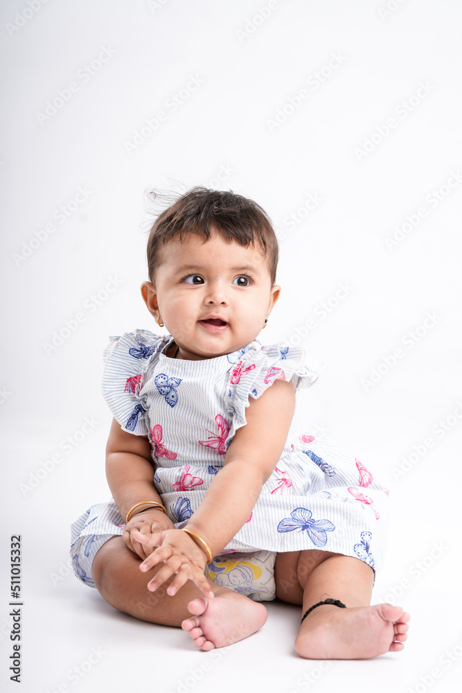Indian baby girl sitting on white background. Indian baby girl sitting on white background.