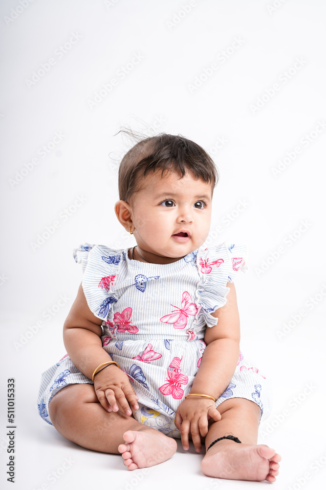 Indian baby girl sitting on white background. Indian baby girl sitting on white background.