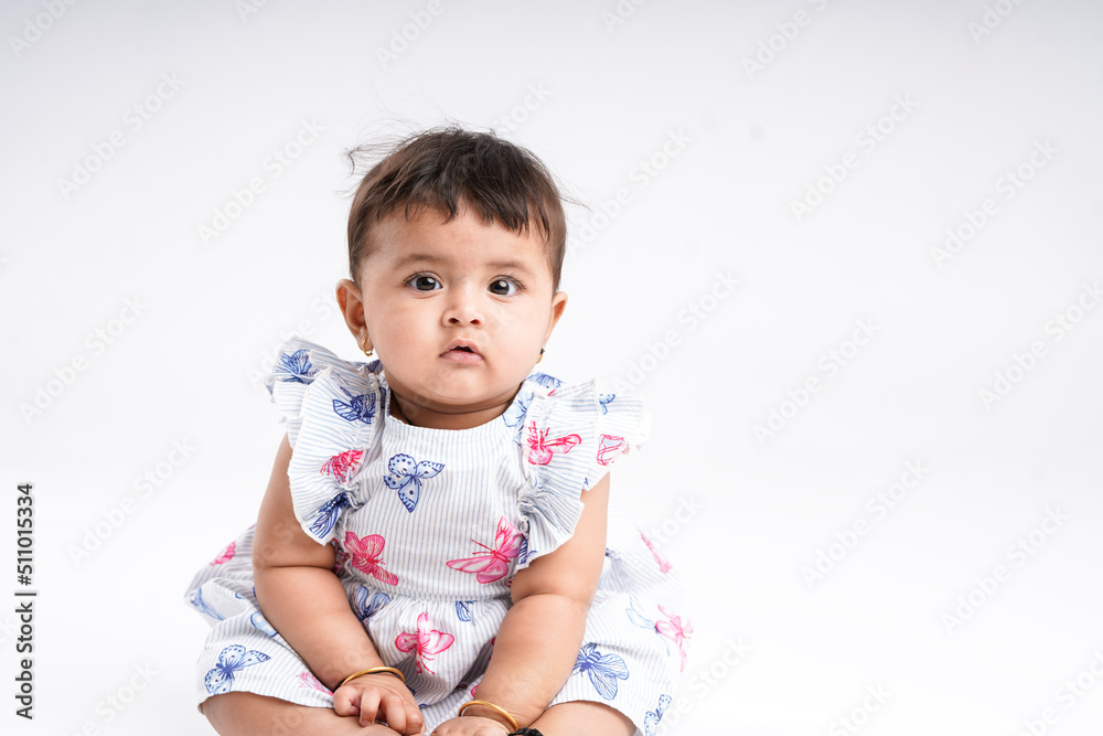 Indian baby girl sitting on white background. Indian baby girl sitting on white background.