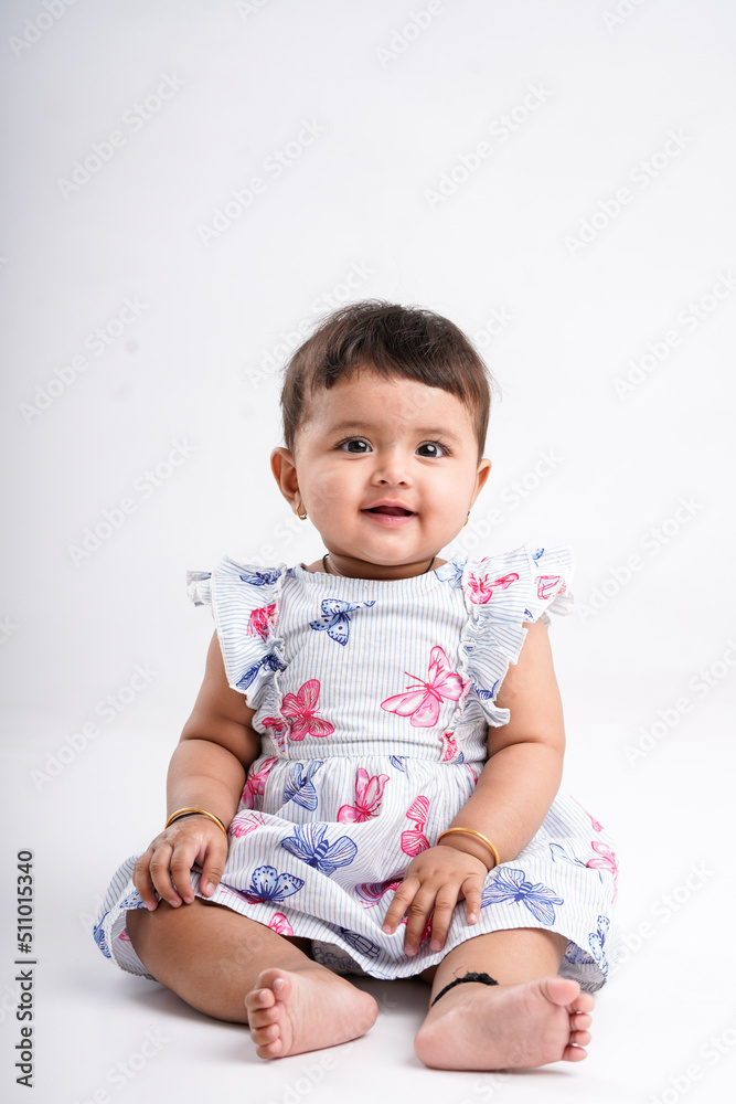 Indian baby girl sitting on white background. Indian baby girl sitting on white background.