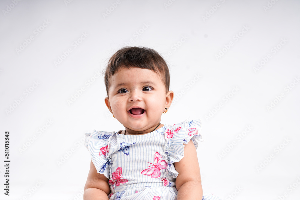 Indian baby girl sitting on white background. Indian baby girl sitting on white background.