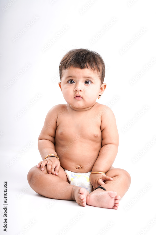 Indian baby girl playing on white background. Indian baby girl playing on white background.