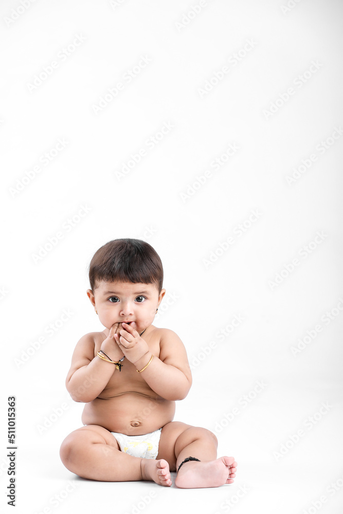 Indian baby girl playing on white background. Indian baby girl playing on white background.